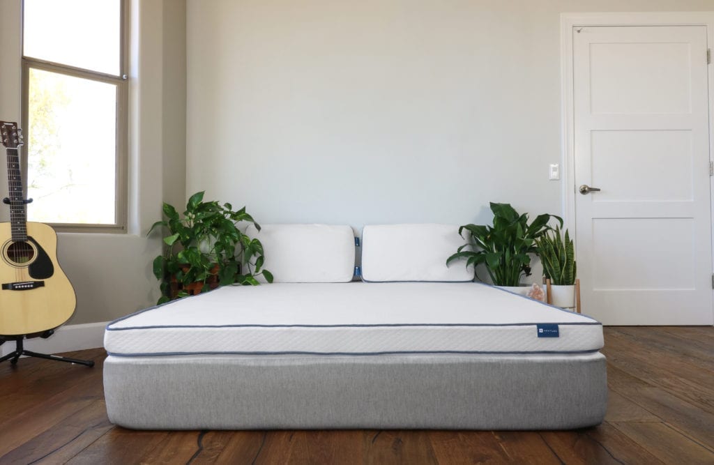 Nestled organic latex mattress topper in a bedroom