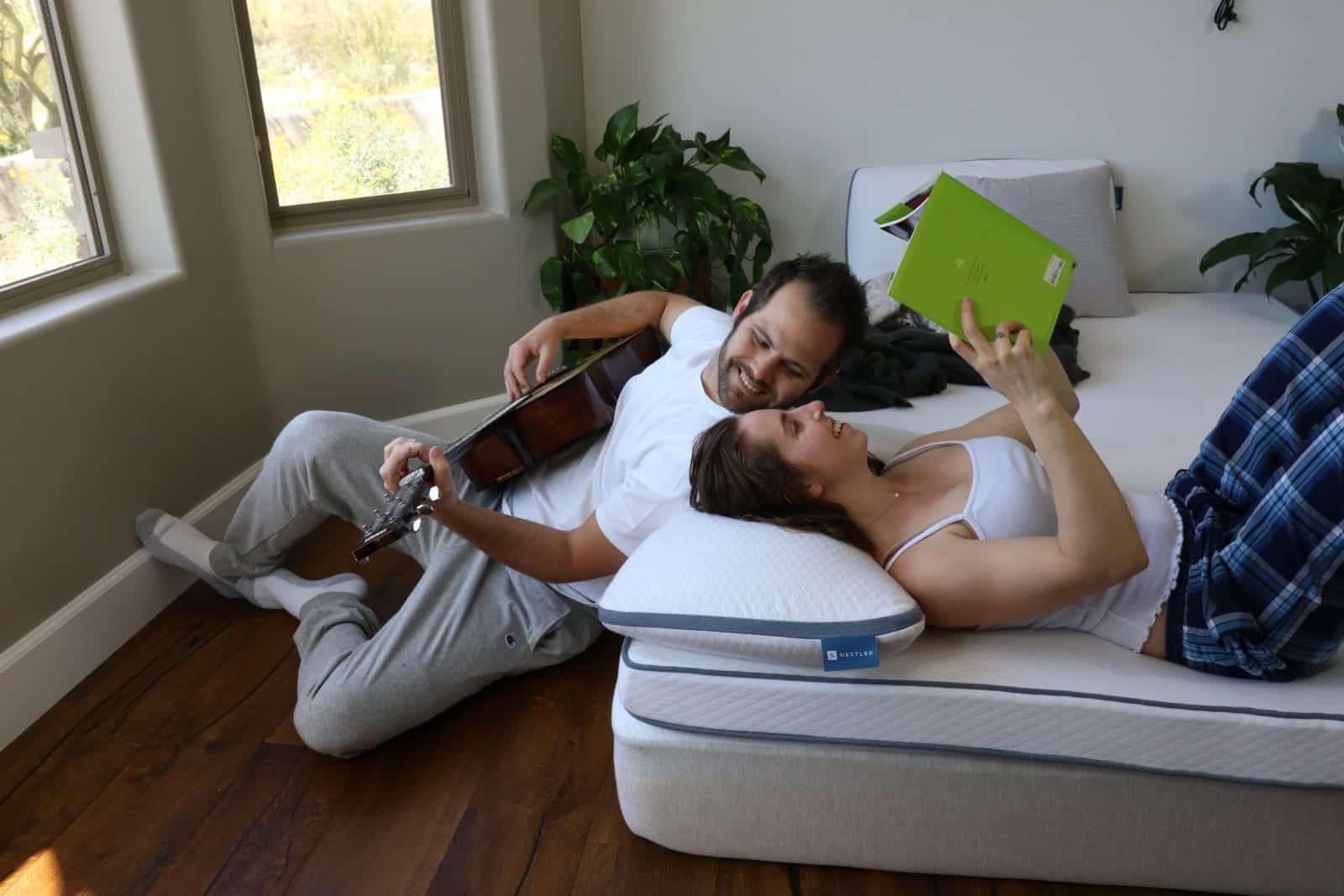 A happy couple enjoying their Nestled topper and pillows.
