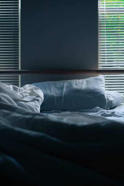 unmade blue bedding in bedroom