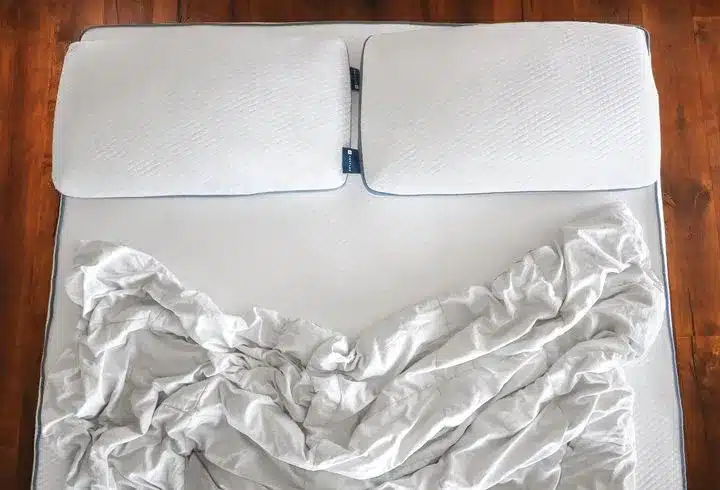 A Latex Queen Mattress with pillows and sheets