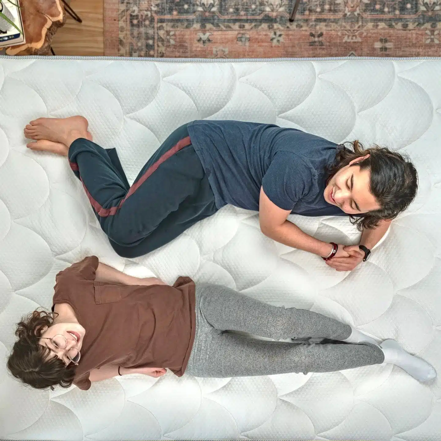 A view from above of a woman and a man on a mattress 
