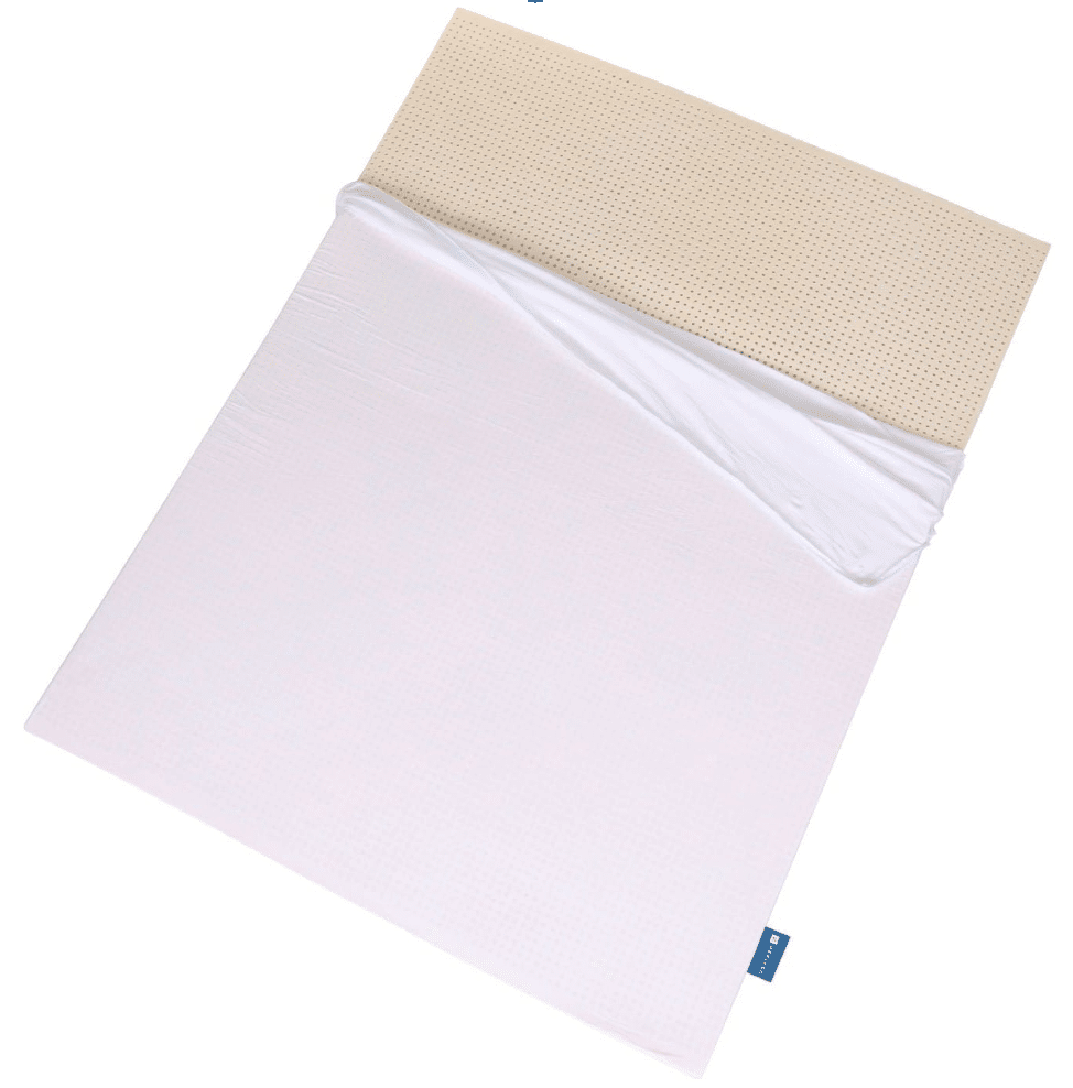 An organic mattress topper from Naturally Nestled is shown partially covered by a sheet