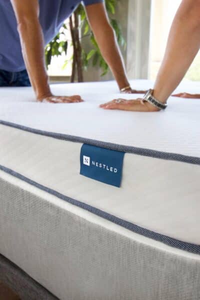 Two people testing mattress toppers for couples from Naturally Nestled